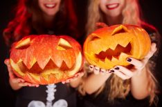 Photo of carved Halloween pumpkins on female palms